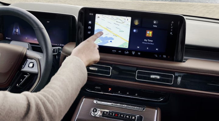 A person is tapping the center display touchscreen of a 2026 Lincoln Aviator® SUV. | Deacon Jones Lincoln in Goldsboro NC