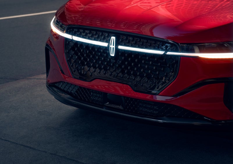The available front LED light bar and center Lincoln Star logo glow at dusk. | Deacon Jones Lincoln in Goldsboro NC
