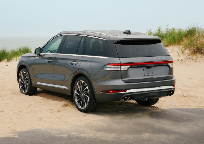 A 2027 Lincoln Aviator® SUV is parked next to sand dunes. | Deacon Jones Lincoln in Goldsboro NC