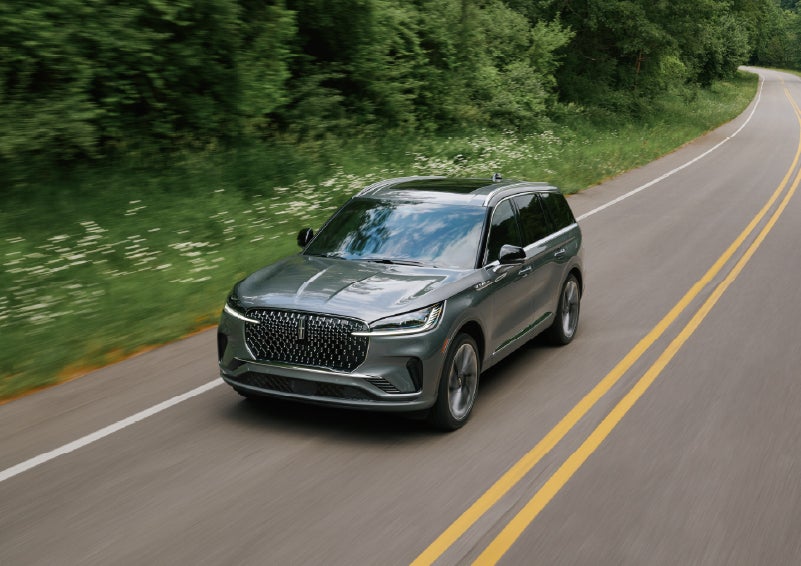 A 2027 Lincoln Aviator® SUV is being driven down a road. | Deacon Jones Lincoln in Goldsboro NC