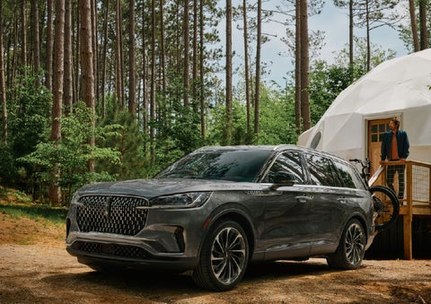 A 2027 Lincoln Aviator® is parked next to a high end glamping site. | Deacon Jones Lincoln in Goldsboro NC