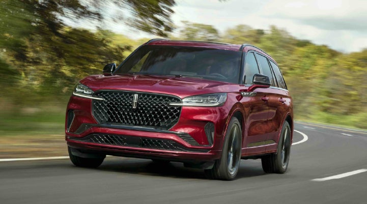 A 2027 Lincoln Aviator® SUV is being driven on a country road | Deacon Jones Lincoln in Goldsboro NC