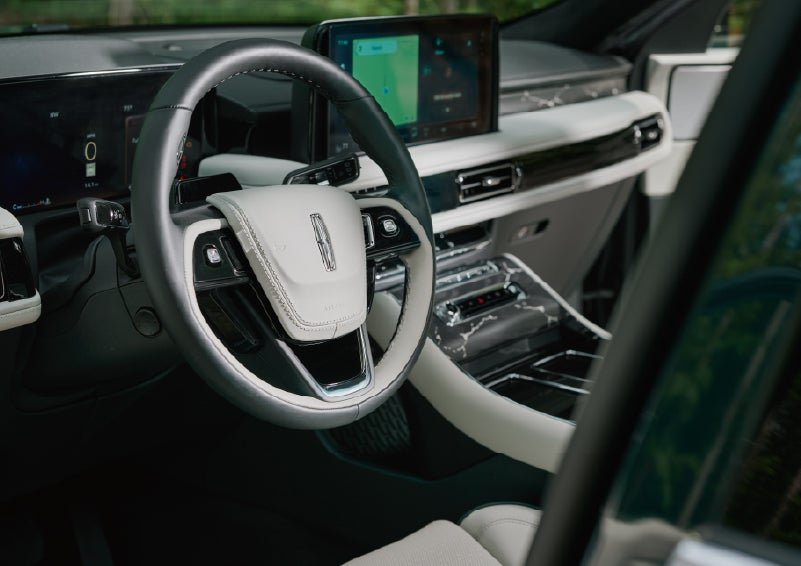 The leather-trimmed steering wheel of a 2027 Lincoln Aviator® Black Label™ SUV. | Deacon Jones Lincoln in Goldsboro NC