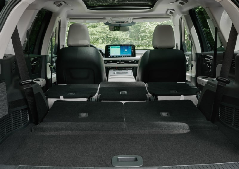 A rear to front view of the interior of a 2027 Lincoln Aviator® Black Label™ SUV shows the third and second rows folded flat | Deacon Jones Lincoln in Goldsboro NC