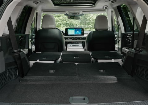 A rear to front view of the interior of a 2027 Lincoln Aviator® Black Label™ SUV shows the third and second rows folded flat | Deacon Jones Lincoln in Goldsboro NC